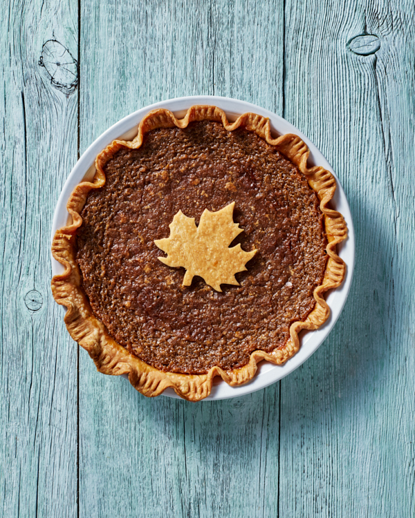 Tarte au Sucre, or sugar pie, in a white pie plate topped with a Maple Leaf design.