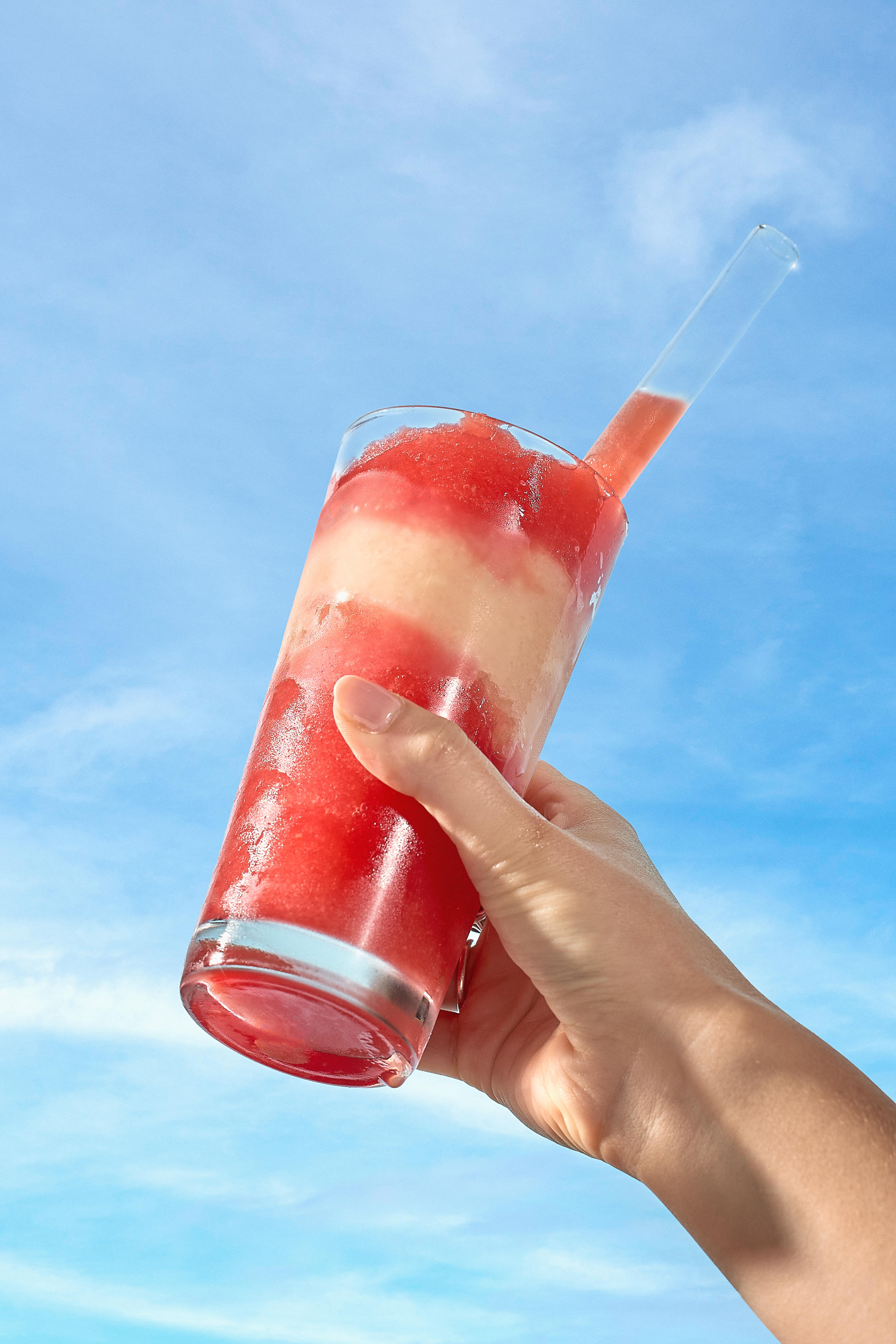Close up of Watermelon Lychee slushie, showing a layer of lychee slushie dividing two layers of watermelon slushie
