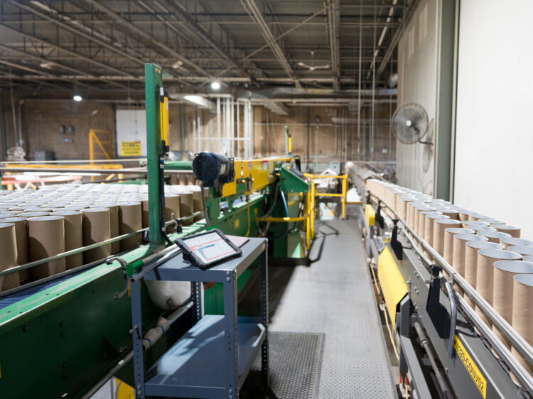 Conveyor lines carrying cardboard canisters inside a Redpath facility