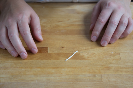 8. Now it is time to make the handle. To do this roll a very thin line of fondant into a log and cut about an inch. Form the log into a €œ9€ shape dip in a little bit of water and attach to the side of the teapot.