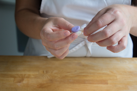 8. Now it is time to make the handle. To do this roll a very thin line of fondant into a log and cut about an inch. Form the log into a €œ9€ shape dip in a little bit of water and attach to the side of the teapot.