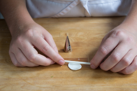 16. Make a tea cup saucer by rolling out a small amount of fondant and cutting small circles with a piping tip. Place the cup on the saucer with a little bit of water.