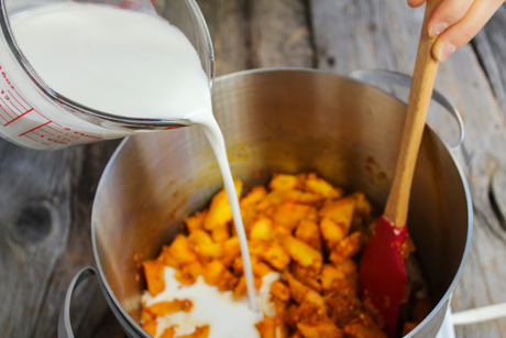 8. Pour the coconut milk and vegetable stock over the pumpkin and bring to a boil and simmer for 10-15 minutes.