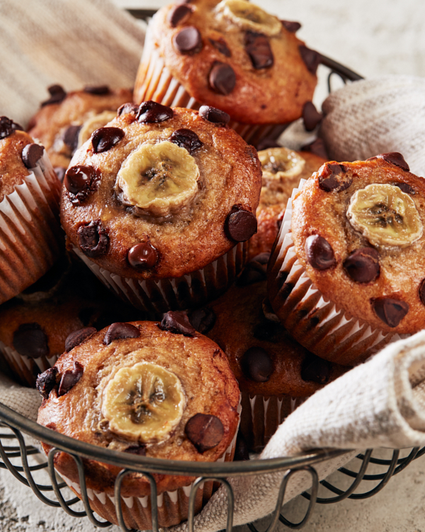 Vegan Banana Chocolate Chip Muffins in a wire bowl.