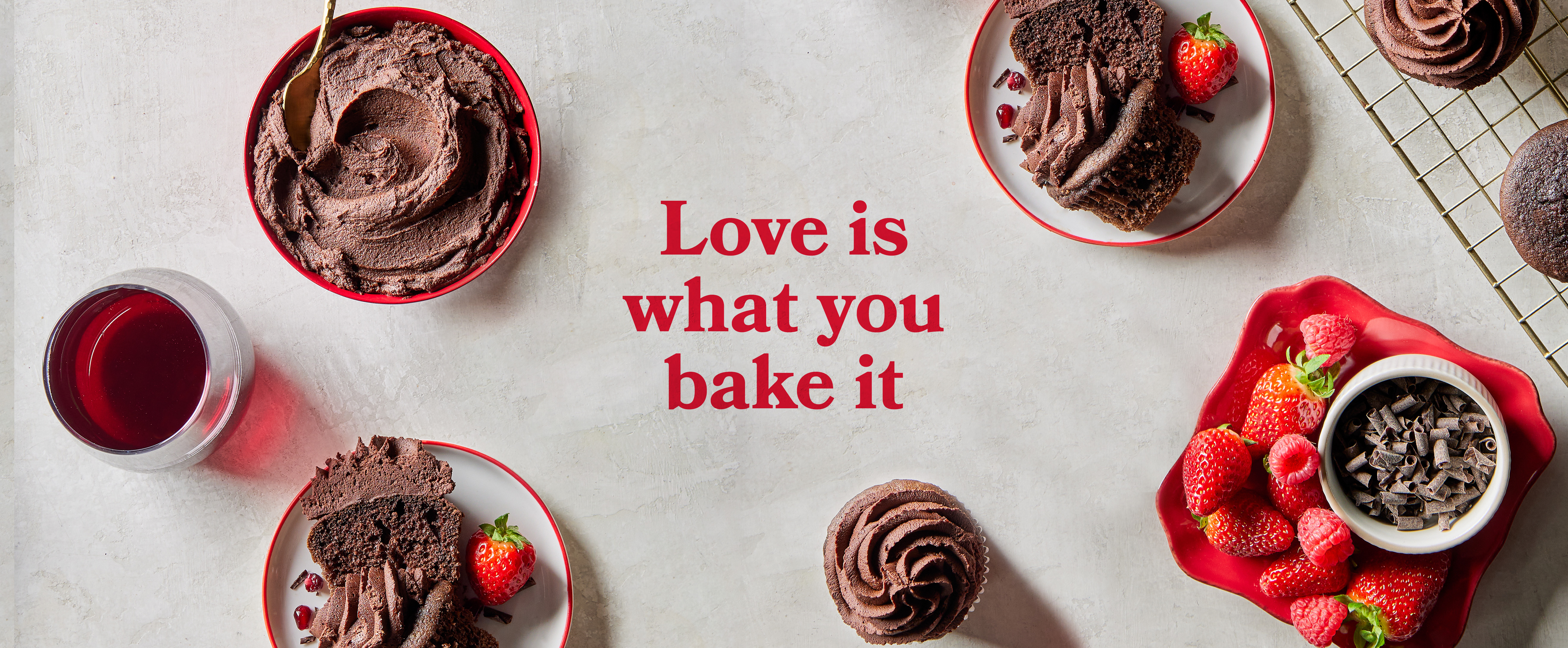 Flatlay of red wine cupcakes with text Love is what you bake it