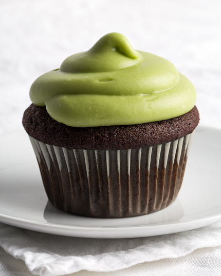 Single Chocolate Cupcake with Avocado Icing on a white plate