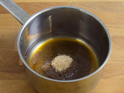 Saucepan with water and partially dissolved Demerara sugar