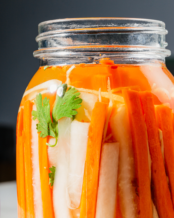 A jar of pickled carrots and daikon radishes