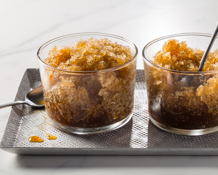 Two glass bowls of coffee granita on a serving tray