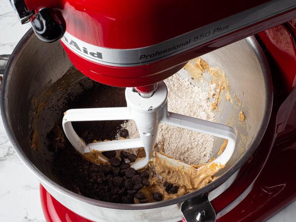 Dark chocolate piece and chips, flour and cocoa powder with creamed brown sugar in a stand mixer bowl