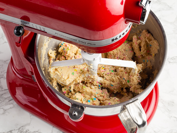Cookie dough with sprinkles in a stand mixer