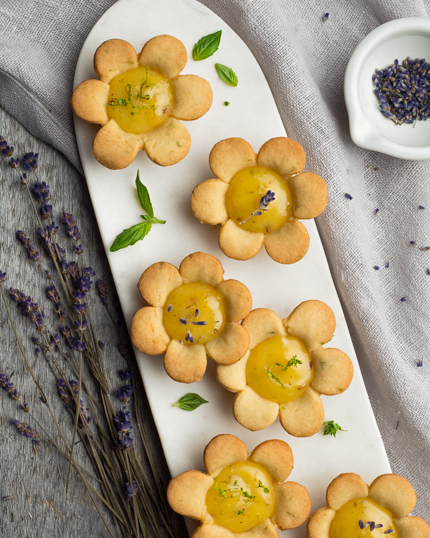 Flower tartlets on a white narrow marbled platter