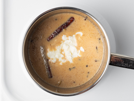 Bloomed gelatin in a pot of buttermilk, heavy cream, and spices