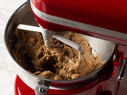 Gingerbread spiced sugar cookie dough in a stand mixer bowl