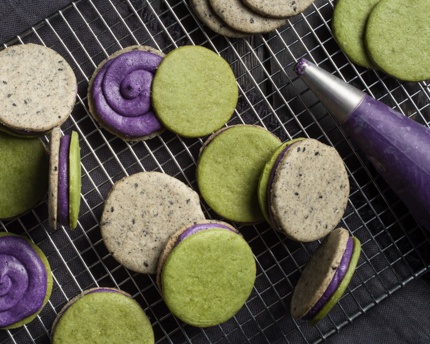 Halloween Sandwich Cookies with Ube Frosting on a wire cooling rack