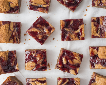 Peanut Butter and Jelly Bars on parchment paper