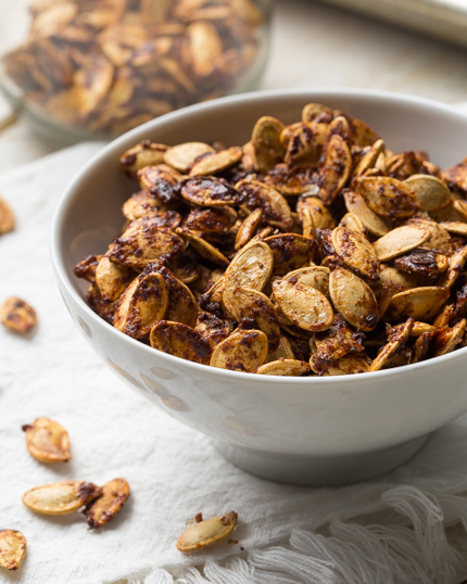 Roasted pumpkin seeds with brown sugar and seasoning in a bowl