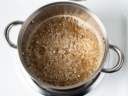 Sugar starting to boil in a pot on a stove