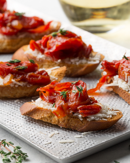 Crostini with tomato jam and cheese on a platter