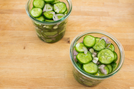 Pickled cucumber and shallots in mason jars