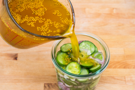 Pickling liquid poured into salted cucumber and shallots