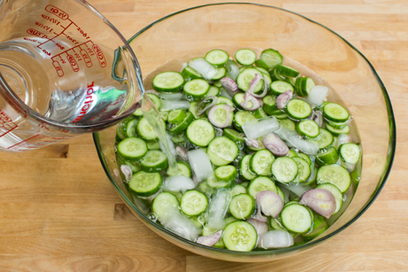 Salting liquid poured over cucumber and shallots