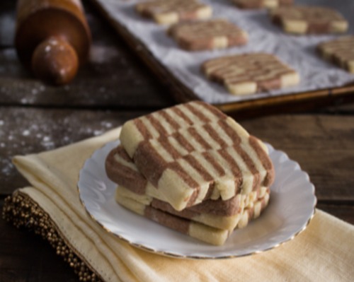 Checkerboard Icebox Cookies stacked on a white plate