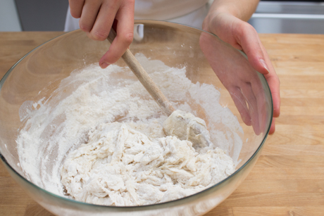 8. Stirring more flour into wet ingredients