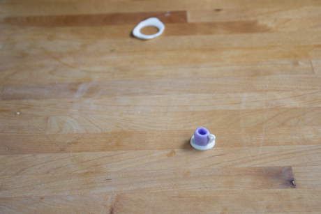 16. Make a tea cup saucer by rolling out a small amount of fondant and cutting small circles with a piping tip. Place the cup on the saucer with a little bit of water.