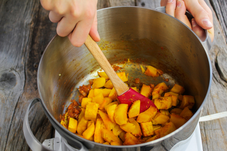 7. Once pumpkin is cooked return pot to medium-high heat and add pumpkin to the onion mixture.