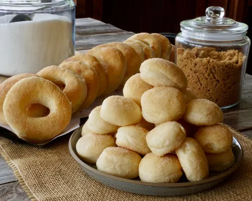 Plates of cinnamon-coated donut and donut holes