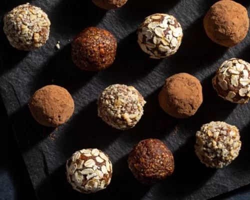  An assortment of fig breakfast bites rolled in nuts and cocoa powder