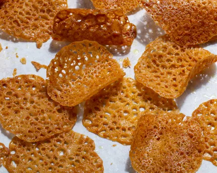 Orange-scented lace tuiles on a marble counter