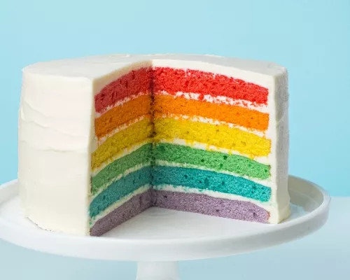 Several layers of colored cake on a cake stand
