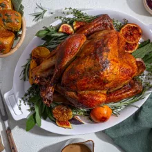 Glazed roast turkey with potatoes and cranberry sauce