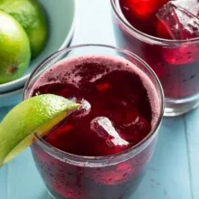 Red Sorrel Drink garnished with a lime slice