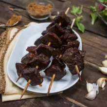 Teriyaki beef skewers on a white plate