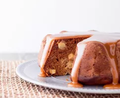 Sliced Bundt cake glazed with caramel served on a white plate