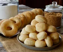 Plates of cinnamon-coated donut and donut holes