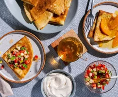 Plates of crepes with fruit toppings and brown sugar whipped sour cream