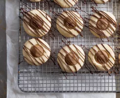 Chestnut Thumbprint Cookies on a wire cooling rack
