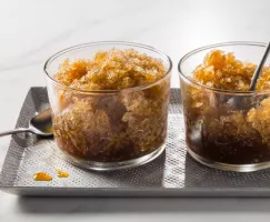 Two glass bowls of coffee granita on a serving tray