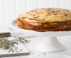 Glazed Ham and Cheese Crêpe Cake on a cake stand