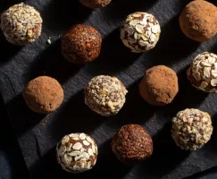  An assortment of fig breakfast bites rolled in nuts and cocoa powder
