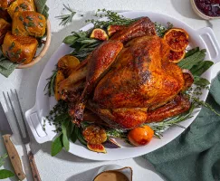 Glazed roast turkey with potatoes and cranberry sauce