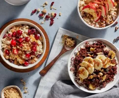 Three bowls of homemade oatmeal with brown sugar, fruit, and berries