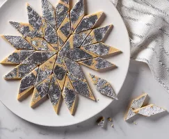 Kaju katli on a plate, cut into diamonds and decorated with silver leaf