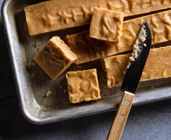 Brown sugar fudge in a baking pan sliced into pieces