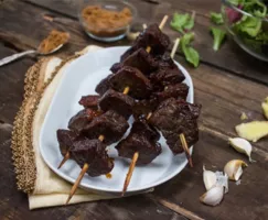 Teriyaki beef skewers on a white plate