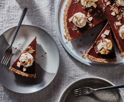 No-bake vegan chai chocolate tart on a platter with two slices cut, one served on a plate